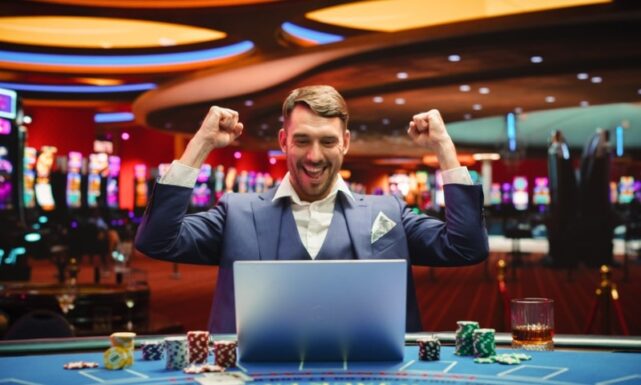 person behind a lap top in a casino