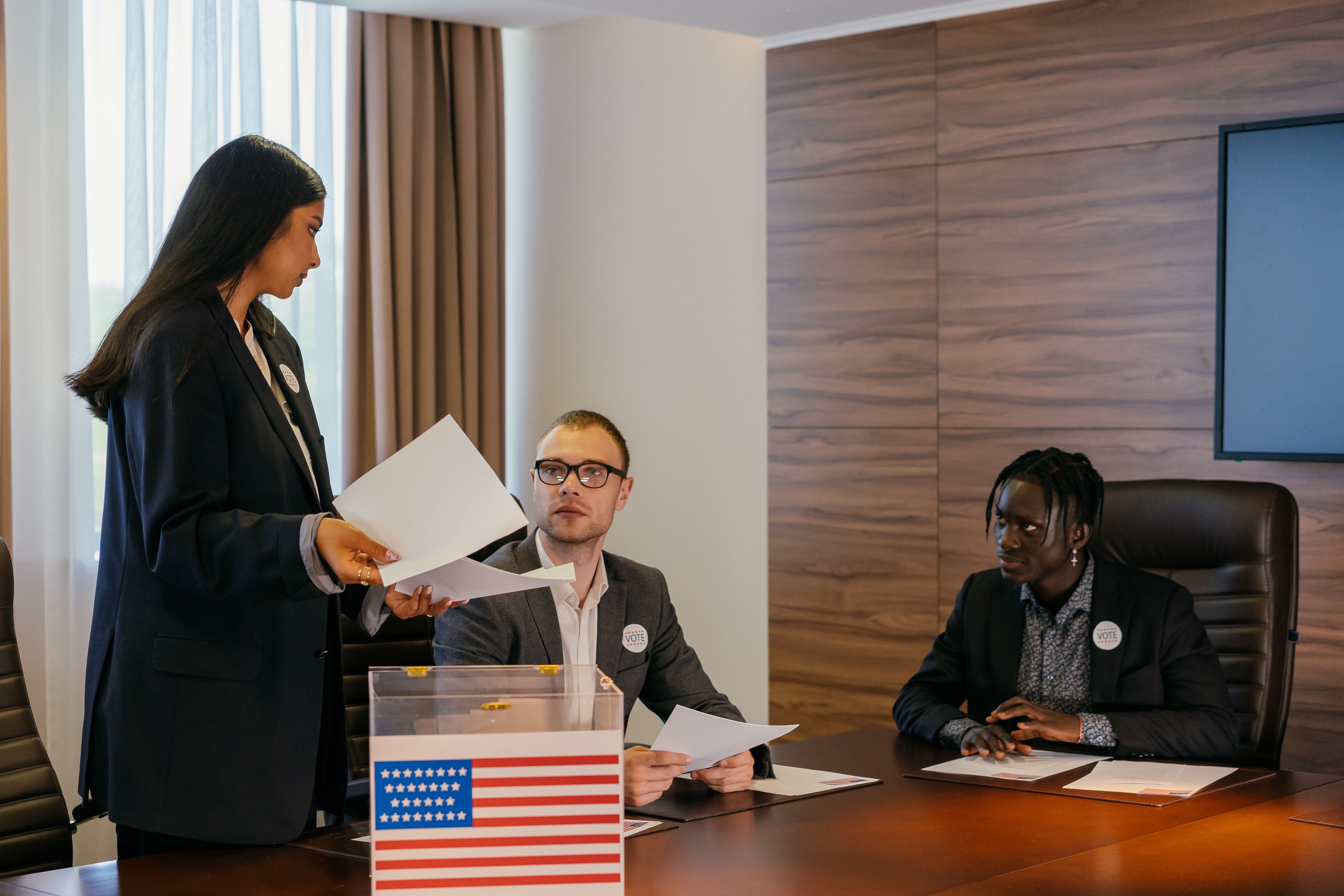 A diverse group of professionals deliberating around a conference table, mirroring coalition negotiation talks
