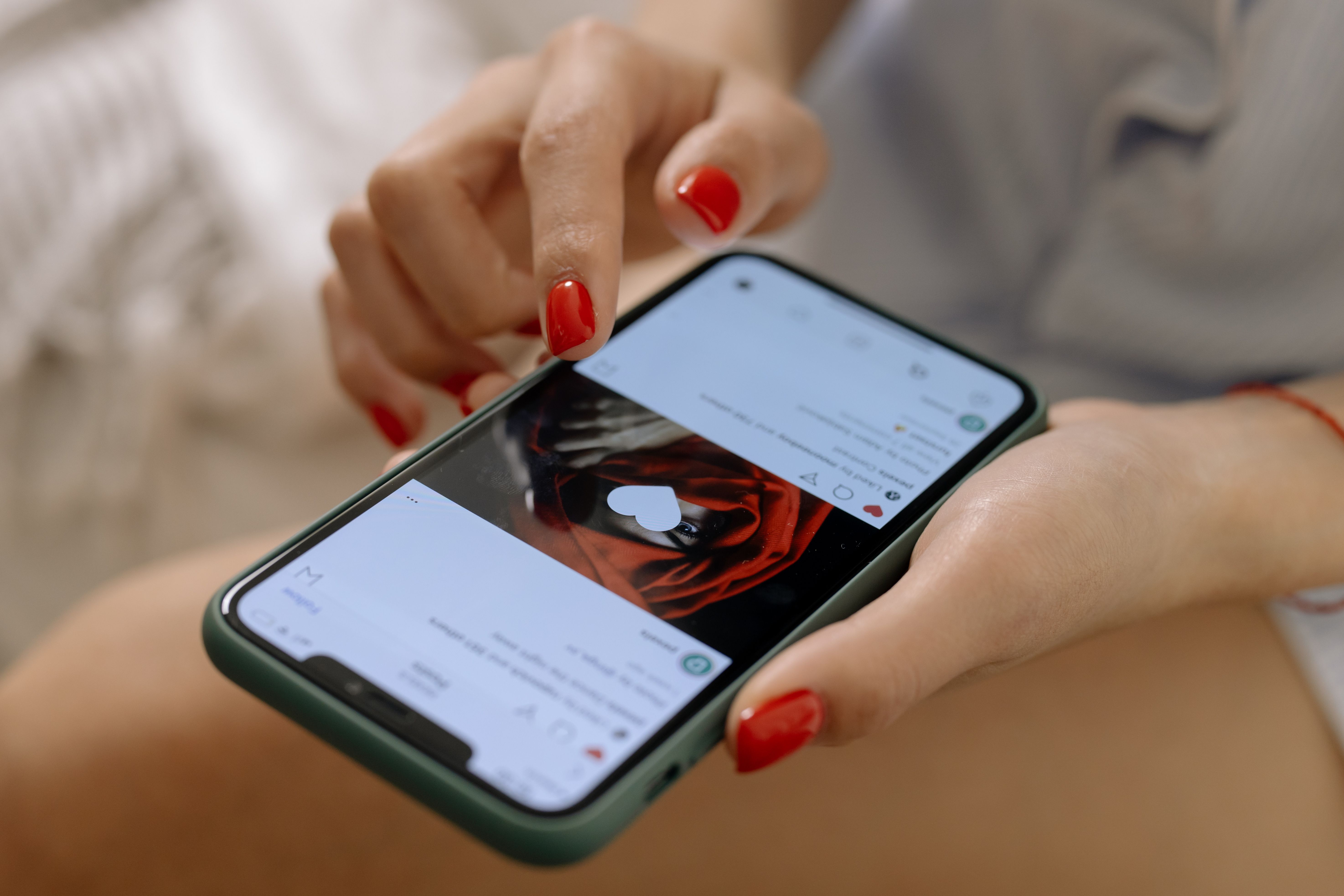 Close-up of hands browsing a smartphone, illustrating social media backlash against public figures