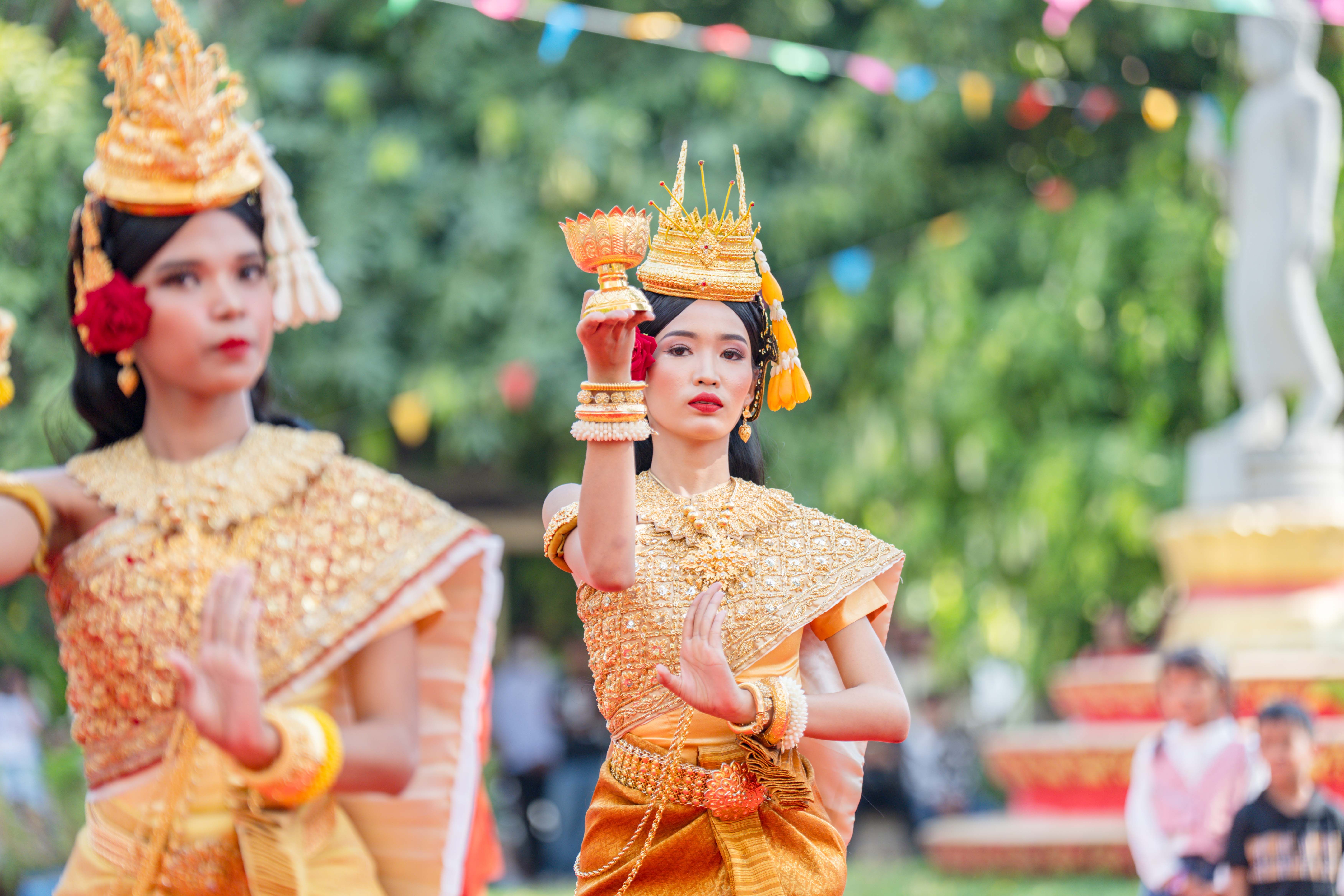 Dancers performing traditional Cambodian dance in vibrant costumes at a festive event in Battambang Province