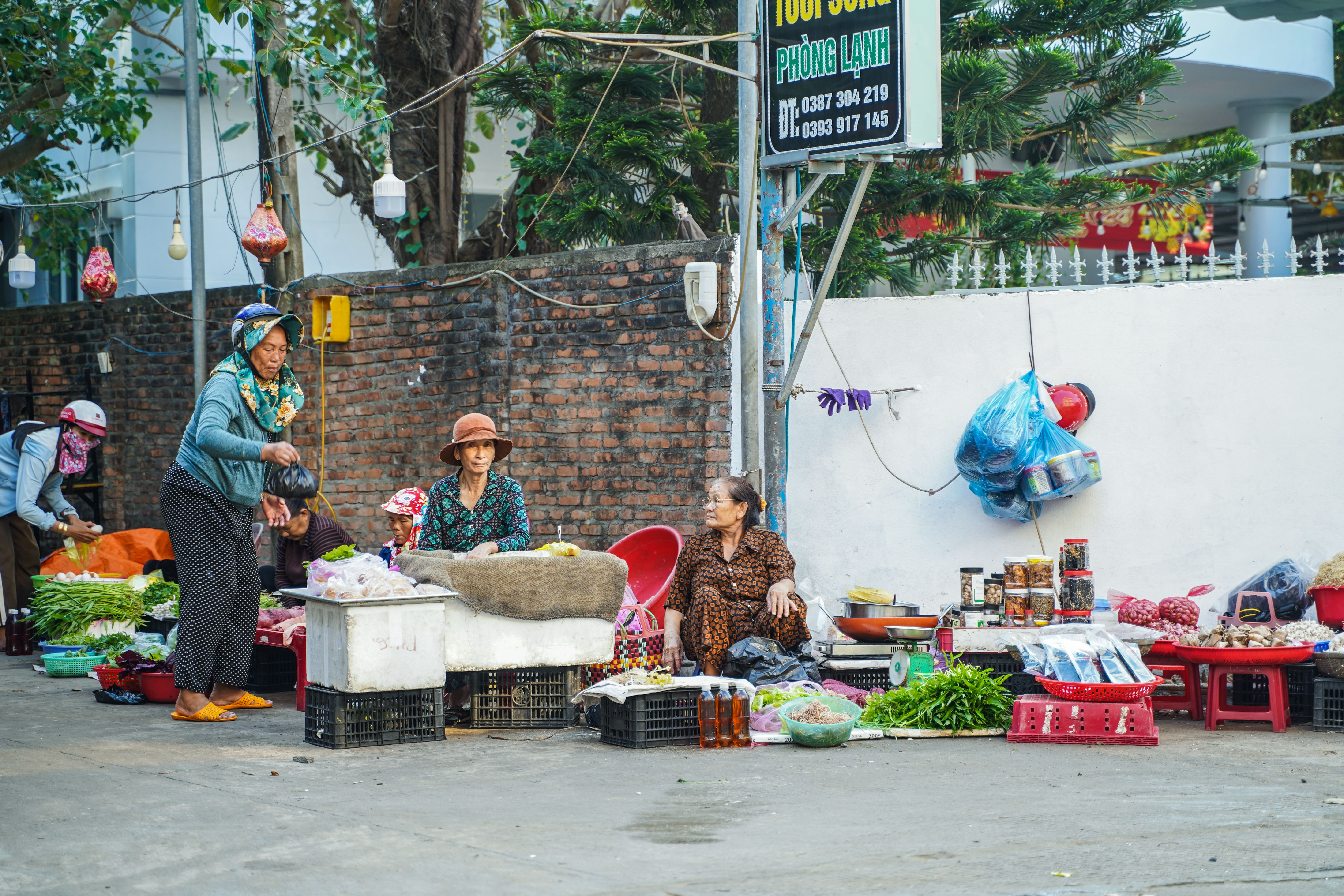 Colorful street market in Vietnam with vendors selling fresh produce and goods